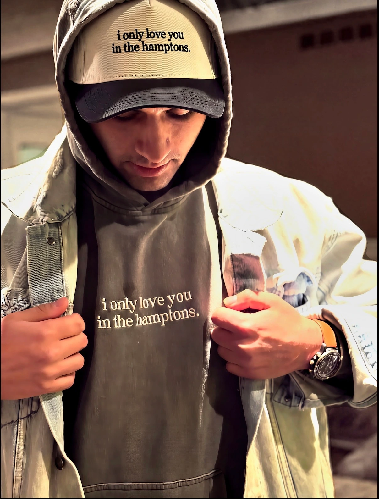 AJ wearing the first i only love you in the hamptons. sweatshirt and cap