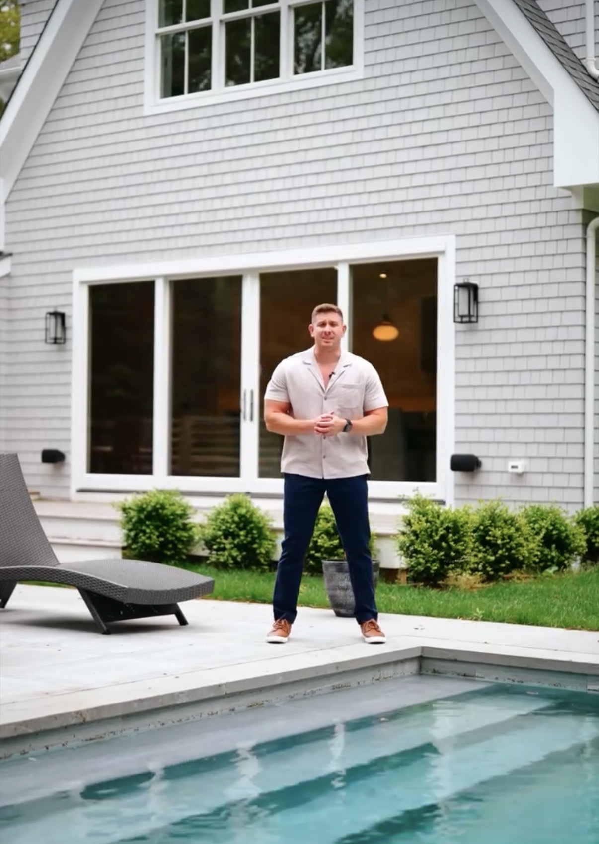 Poolside at a Hamptons gray-shingle house in summer