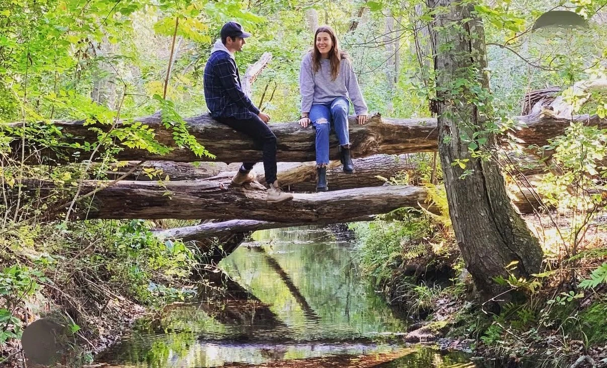 Spring hike over a creek in the Hamptons woods
